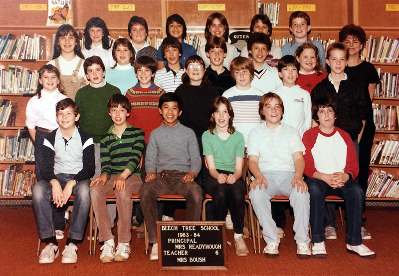 Color photograph of Mrs. Boush’s sixth grade class taken during the 1983 to 1984 school year. 25 students and Mrs. Boush are pictured.